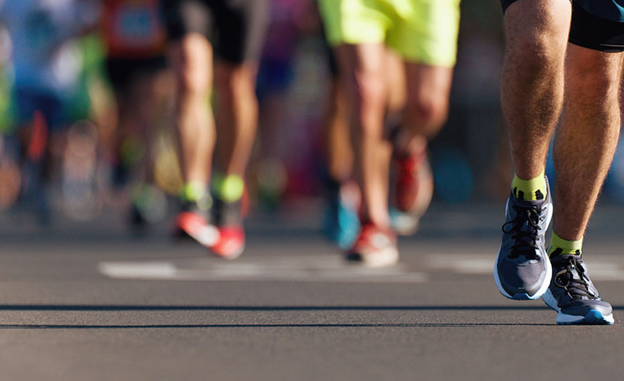 Slightly out of focus picture of the legs of marathon runners